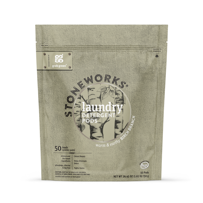 A beige pouch labeled grab green Stoneworks Laundry Detergent Pods in Birch Branch scent, with simple tree designs, holds 50 odor-neutralizing pods.