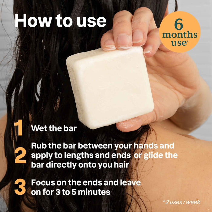 Someone holds the ATTITUDE super leaves Conditioner Volume & Shine Bar against wet hair. Instructions: Wet bar, rub between hands or on hair, focus on ends, leave 3-5 min. Lasts up to 6 months.*.
