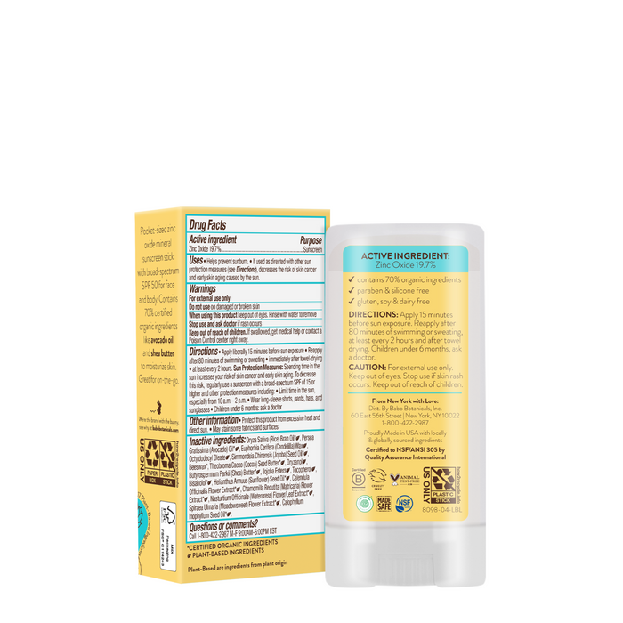 The back of the Babo Botanicals Super Shield Mineral Sunscreen Stick SPF50 and its box show drug facts, directions, natural origin zinc oxide ingredients, and caution info in black text on white and yellow backgrounds.