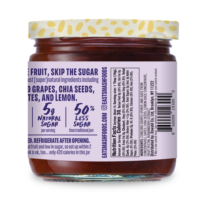 Smash Foods’ Superfood Jam - Raspberry comes in a glass jar with a yellow polka dot lid. The label shows 5g natural sugar, 50% less sugar, and sweeteners like grapes, chia seeds, dates, and lemon. Barcode and social media are visible.