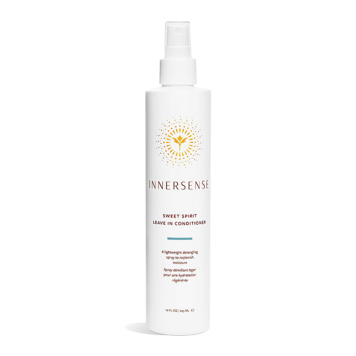 A white bottle of Innersense Organic Beautys Sweet Spirit Leave-In Conditioner, featuring a sunburst logo and a spray nozzle, is infused with Certified Organic plant extracts and elegantly set against a plain white backdrop.