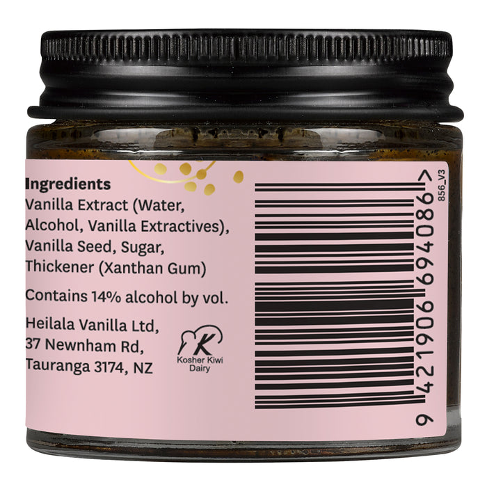 A small jar of Heilala Vanilla Paste features a black lid, pink label with ingredients, barcode, company address in New Zealand, and a Kosher certification symbol.