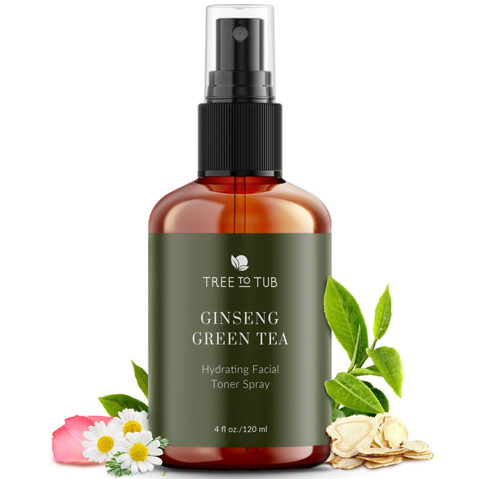 The Tree To Tub Witch Hazel Toner for Sensitive Skin with Green Tea & Ginseng, 4 fl oz, features a black spray nozzle and green label. Nestled among green tea leaves, ginseng root slices, and pink flowers, this alcohol-free toner is ideal for enhancing your witch hazel toner collection.