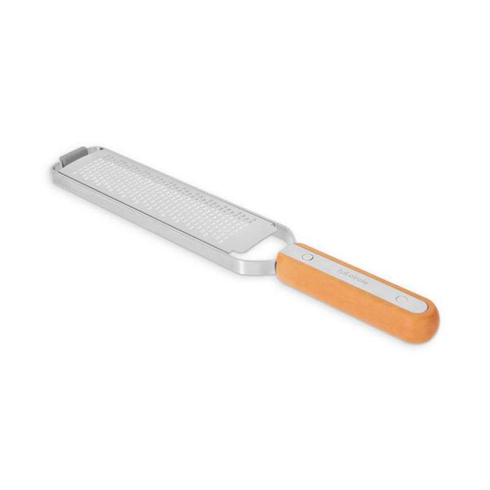 The Full Circle Zester is a stainless steel tool with a fine grating surface and wooden handle, ideal for zesting citrus or shredding hard cheese. Its sleek, modern design adds a touch of elegance to any kitchen.